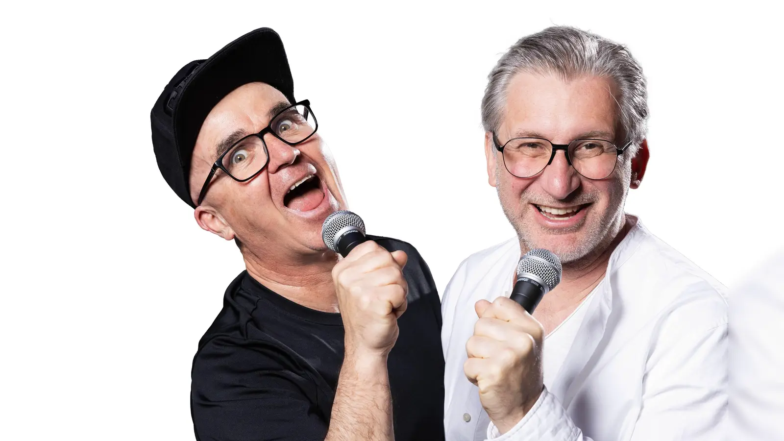 Uli Wurschy (l.) und Volker Becker stehen am 21. Oktober in der Halle E im Gasteig HP8 auf der Bühne und moderieren das Rudelsingen. (Foto: Joachim Pantel)