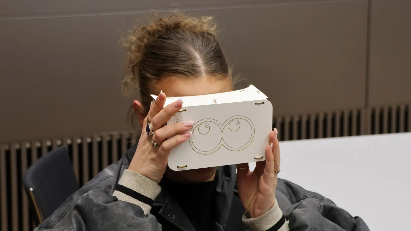 Bei einer Tagung zur Wissenschaftskommunikation wurde es erfinderisch: Hier mit einer DIY-VR-Brille. (Foto: Akademie für Politische Bildung)